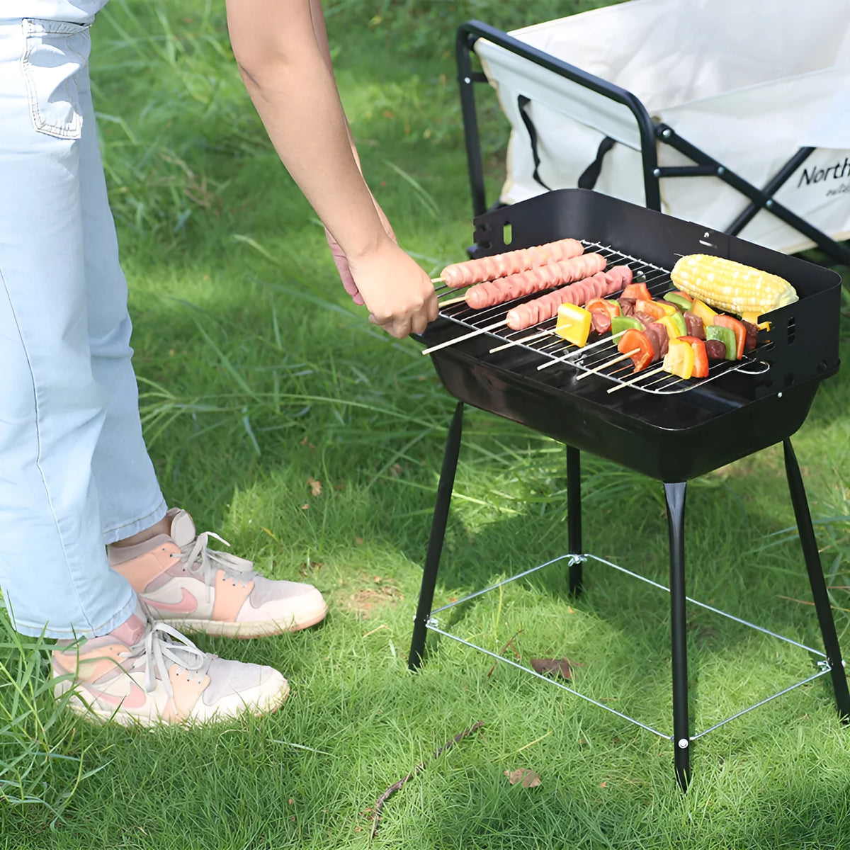 Portable metal barbecue grill, 29x12x44cm, with black grill rack disk for camping and outdoor use