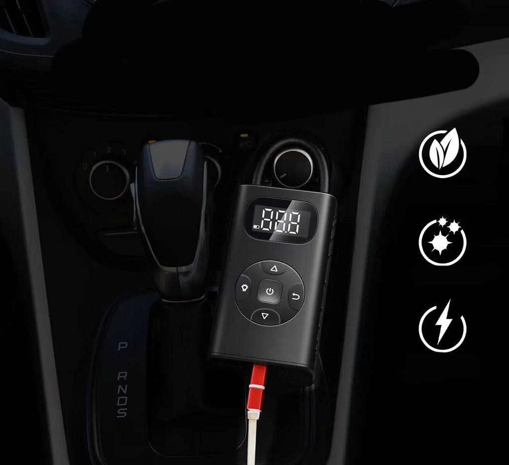 Black rectangular portable tyre inflator and power bank unit with a connected inflation hose on a table.