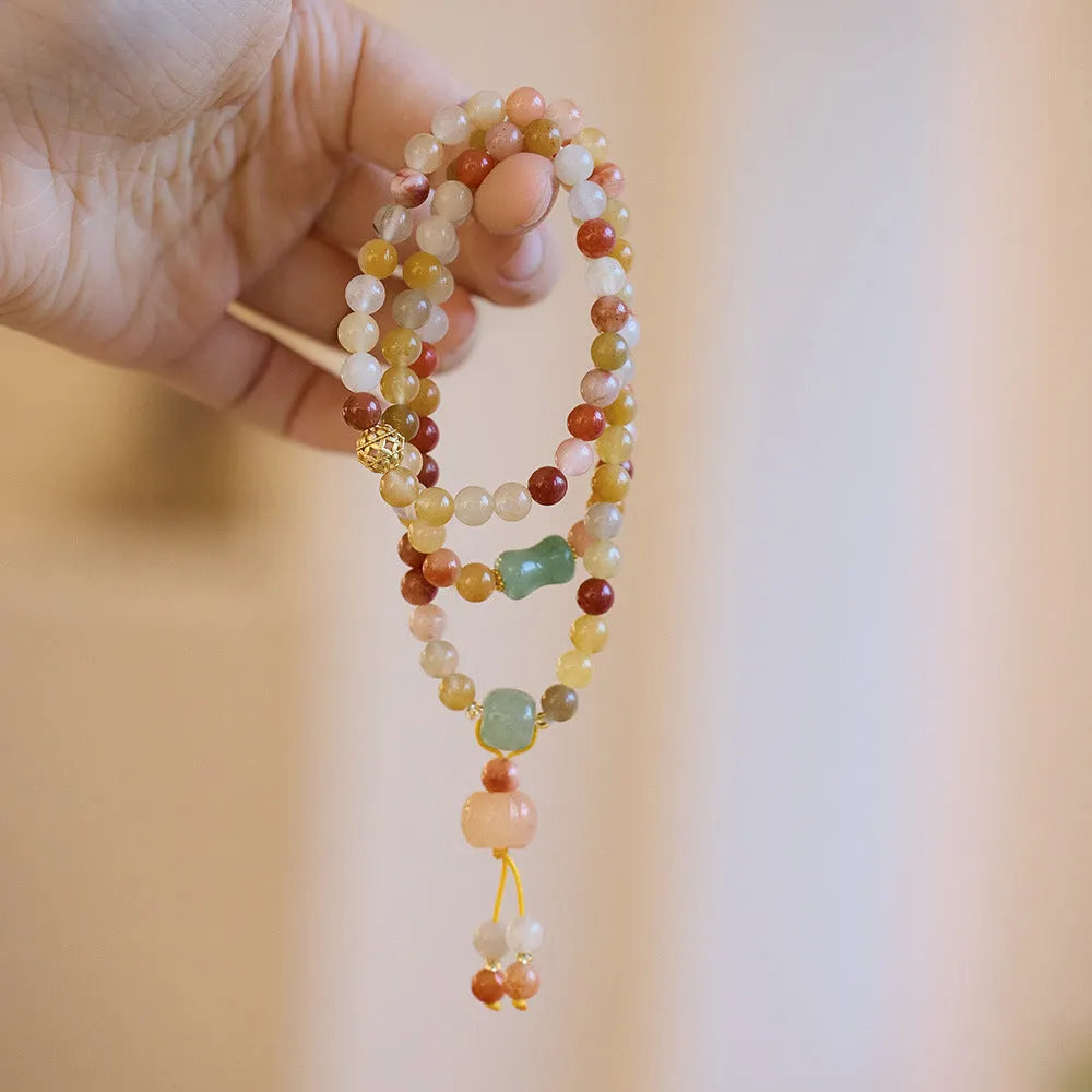 Women's handcrafted Jinsi Jade bracelet with three pumpkin circles and tassel decoration