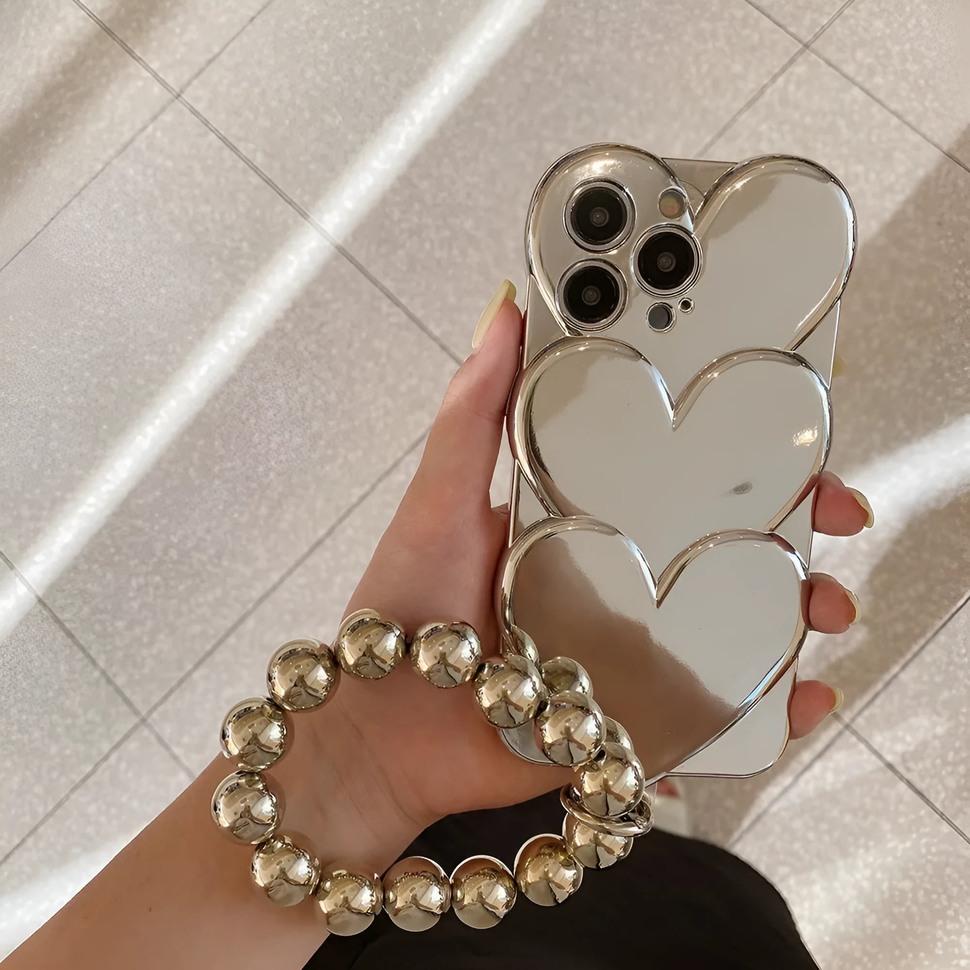 Electroplating love design TPU soft shell iPhone case shown on phone with optional matching bracelet