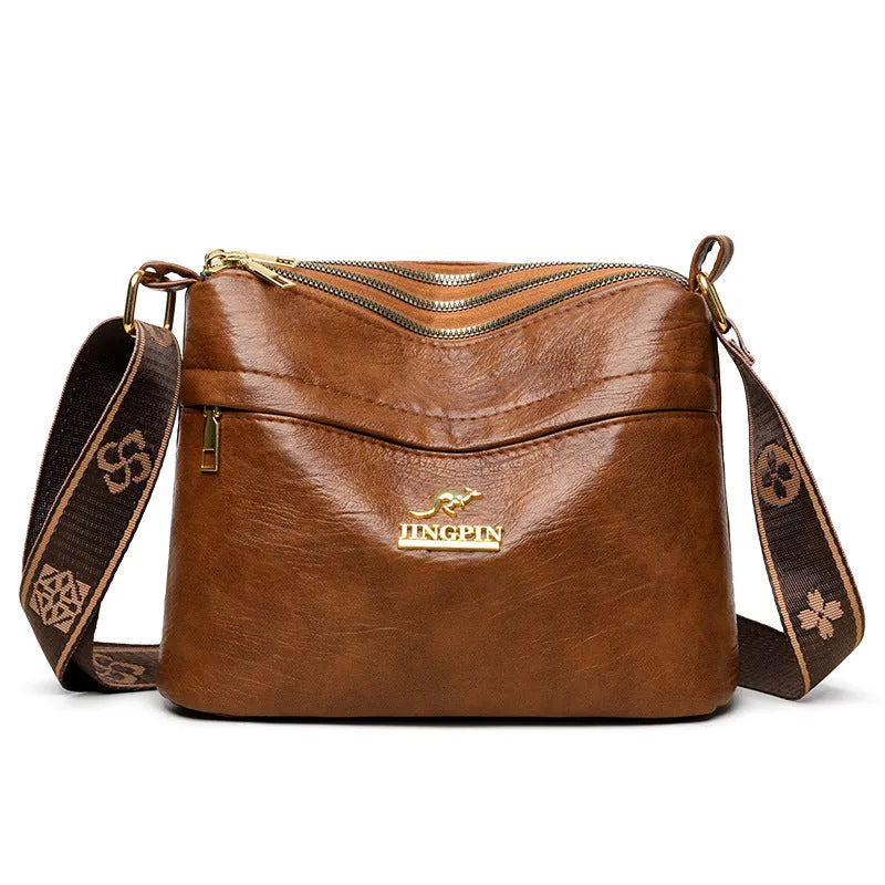 Cross body messenger bag in horizontal square shape with multiple compartments and sandwich pocket construction