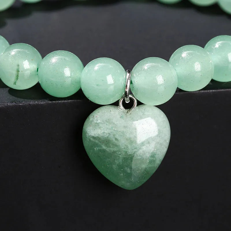 Natural stone bracelet with geometric love pendant in tigereye, crystal, aventurine, jade, and unakite stones
