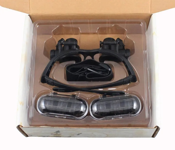 Black double eye magnifier glasses with LED lights and interchangeable lenses for precision repair work