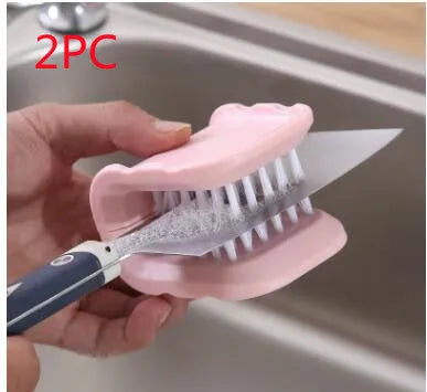 Blue U-shaped plastic brush for cleaning kitchen forks, knives and spoons on a countertop.