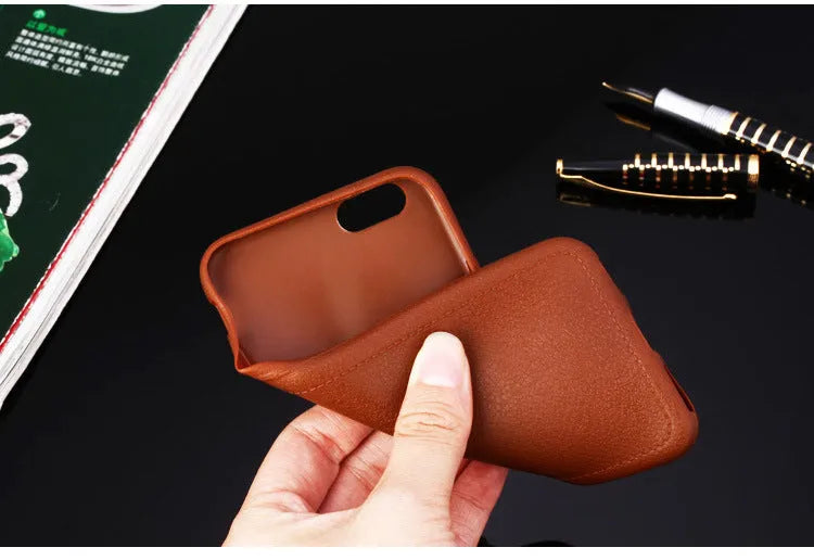 Genuine leather phone case for Apple iPhone in black, shown fitted to an iPhone 11 model.