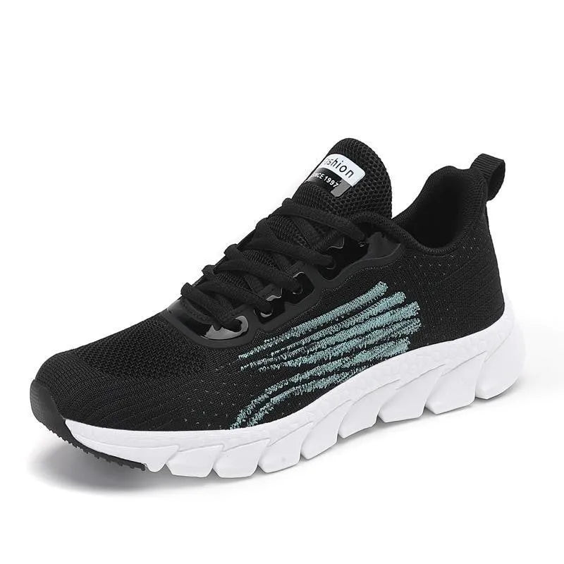 Low-top black and white running sneaker with cross strap and round toe on MD sole.