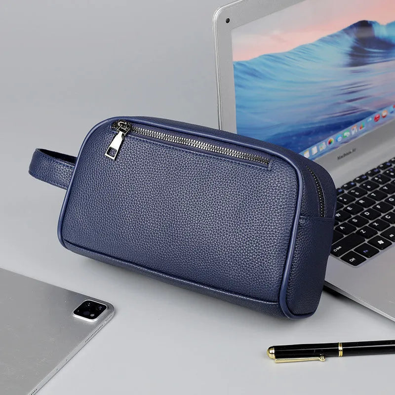 Men's business clutch bag in soft PU leather with large capacity, solid colour finish and zip closure, available in black, dark blue and brown