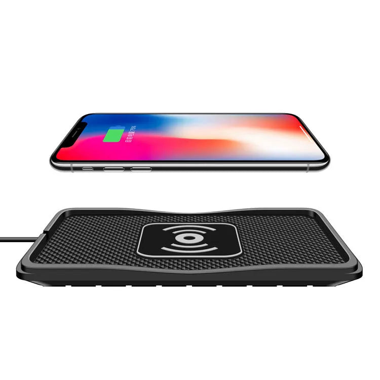 Black wireless car charger with anti-slip base, shown on a car dashboard next to a mobile phone.