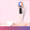Pink and white rechargeable facial massager with red and blue light therapy functions on a clean surface