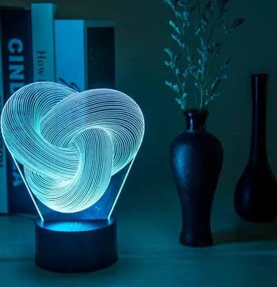 Twist abstract LED 3D night light in colour gradient mode on a wooden table with remote control