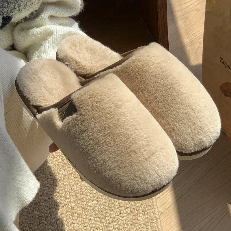 Winter plush slippers in blue with non-slip PVC sole and car stitching detail on the upper.