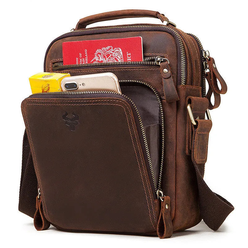 Men's brown Crazy Horse leather crossbody bag with visible sewing lines and adjustable shoulder strap