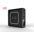 Black Super QI power bank with folding AC plug unfolded, showing wireless charging surface on top.
