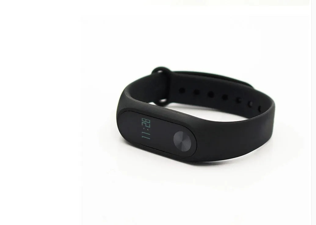 Xiaomi Mi Band 2 black fitness tracker with OLED screen on an adjustable wrist strap.