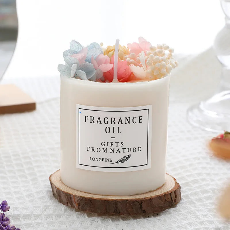 Decorative dried flower candle in jar with wooden chip base, available in nine botanical scents