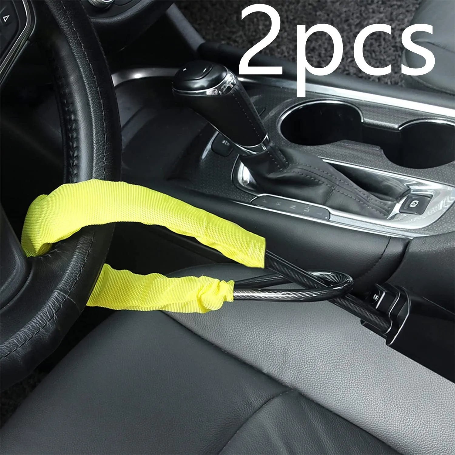 Red car steering wheel lock with iron cable secured around a steering wheel.