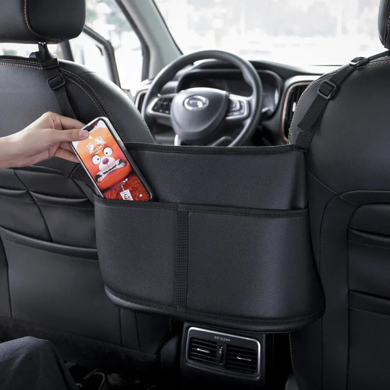 Black leather car seat storage bag with sports carbon fibre pattern, shown on a car seat.