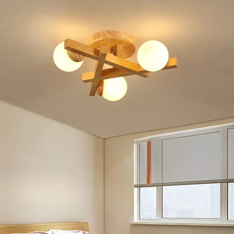 Modern Nordic-style wooden ceiling light fixture with three adjustable lamp heads mounted on a living room ceiling.