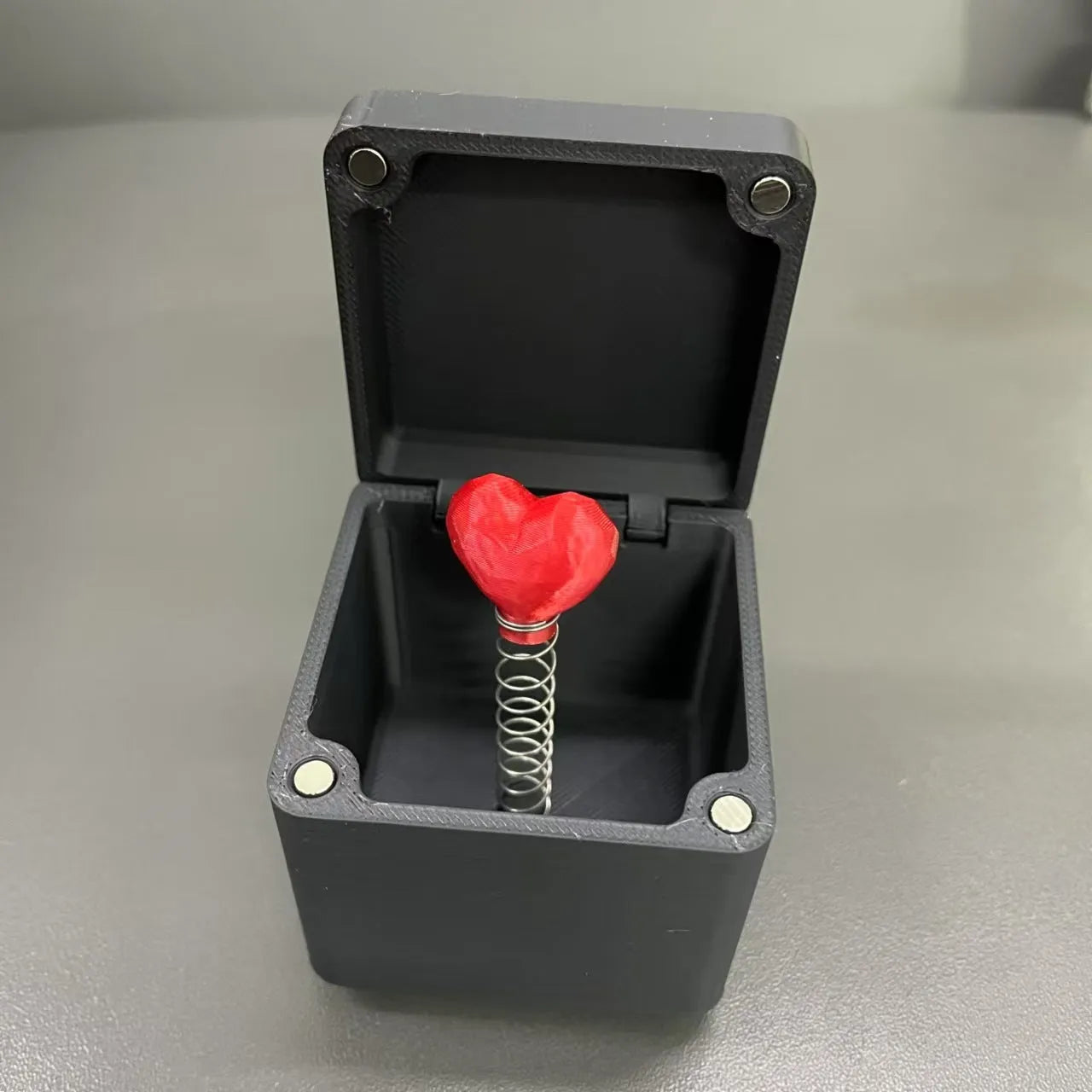 Christmas spoof middle finger gift box, 5cm plastic novelty toy in black and gold