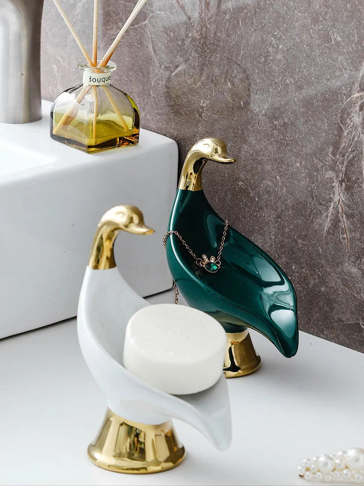 White ceramic swan soap dish with lid cover on bathroom countertop