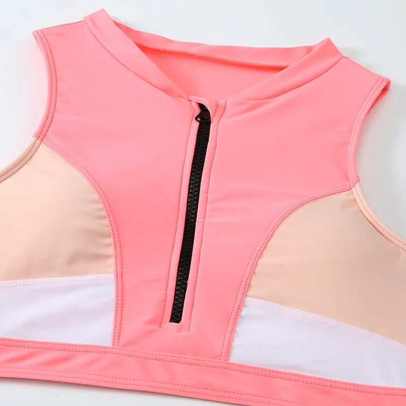 Pink high-waist bikini swimsuit with brief style shorts and a sleeveless top.