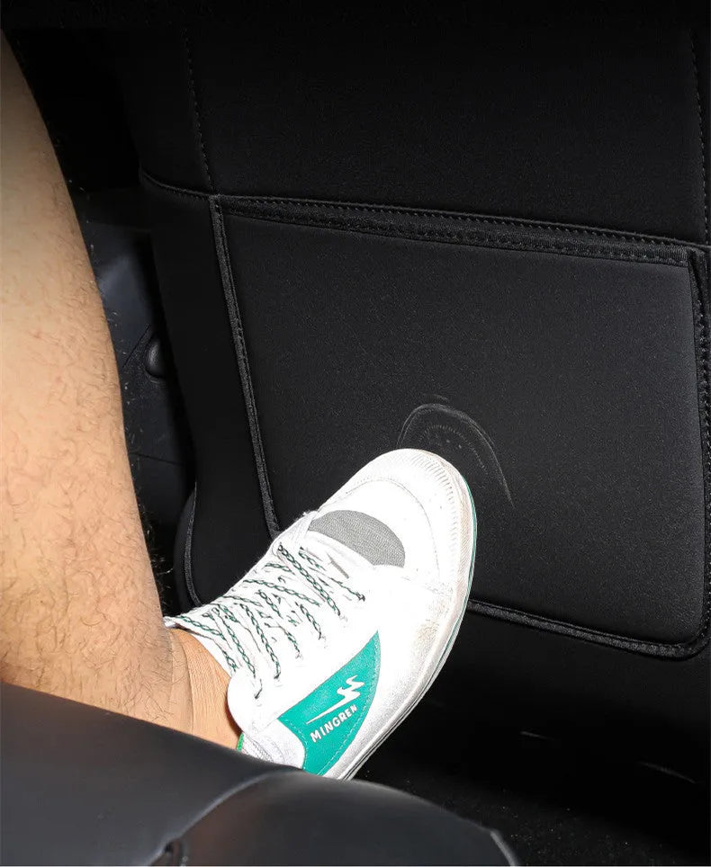 Two black leather rear anti kick pads for car seat back protection.