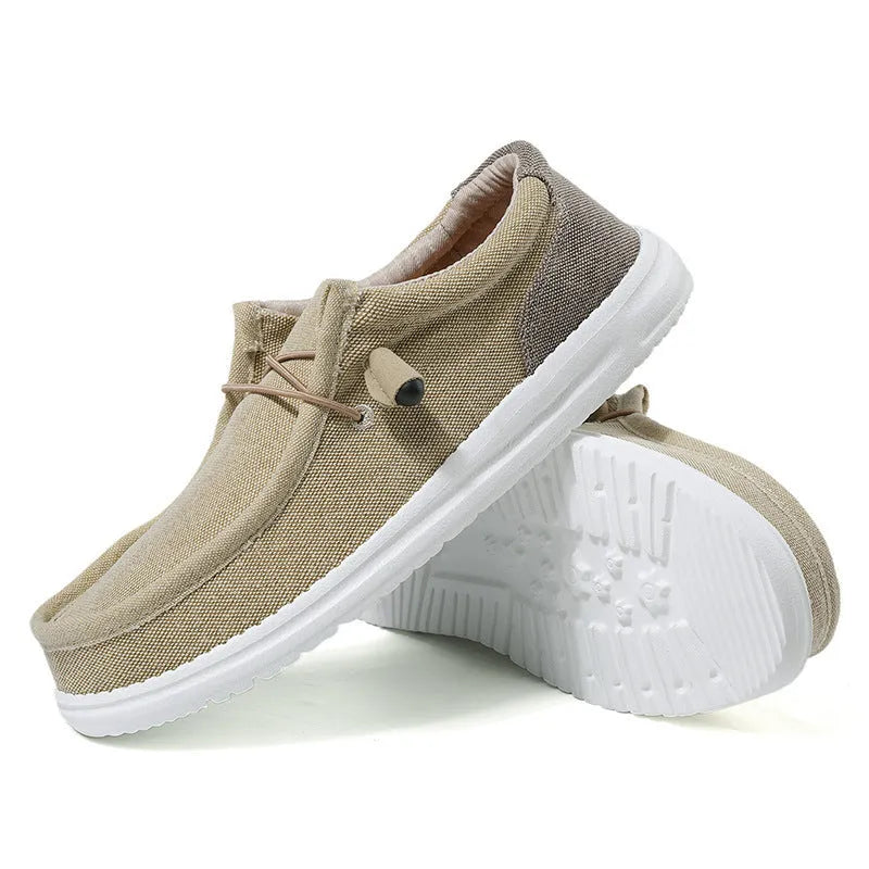 Men's casual canvas shoe in green with mosaic detail and rubber sole, shown from the side.