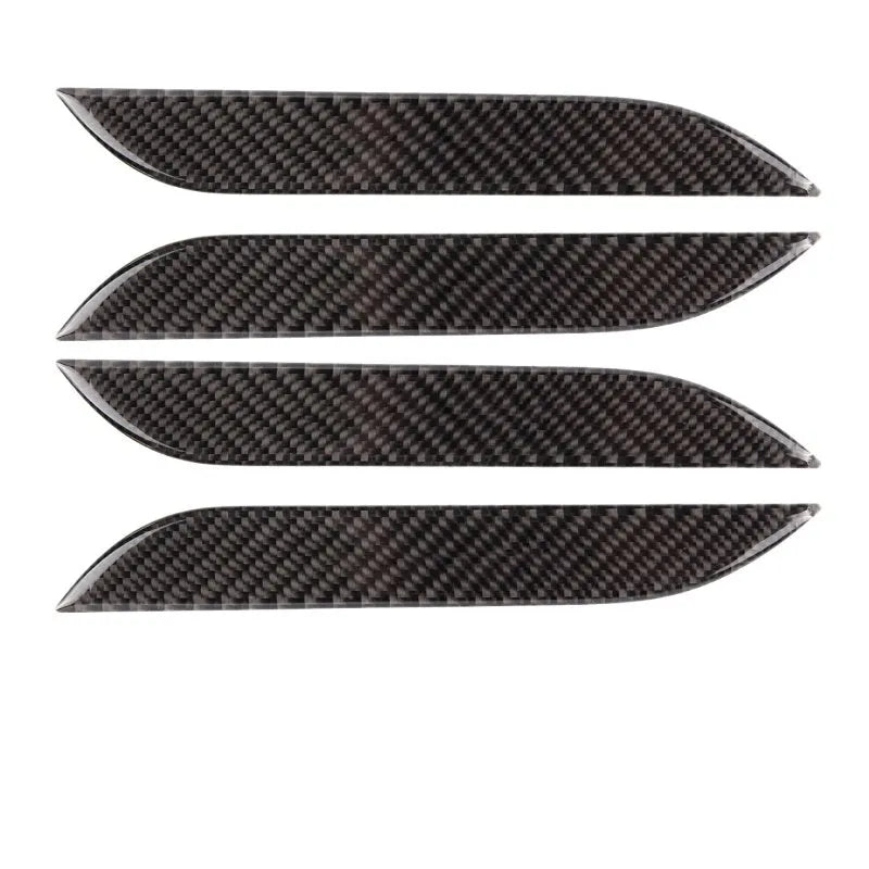 Four black carbon fibre pattern adhesive door handle protectors for a Tesla Model S.