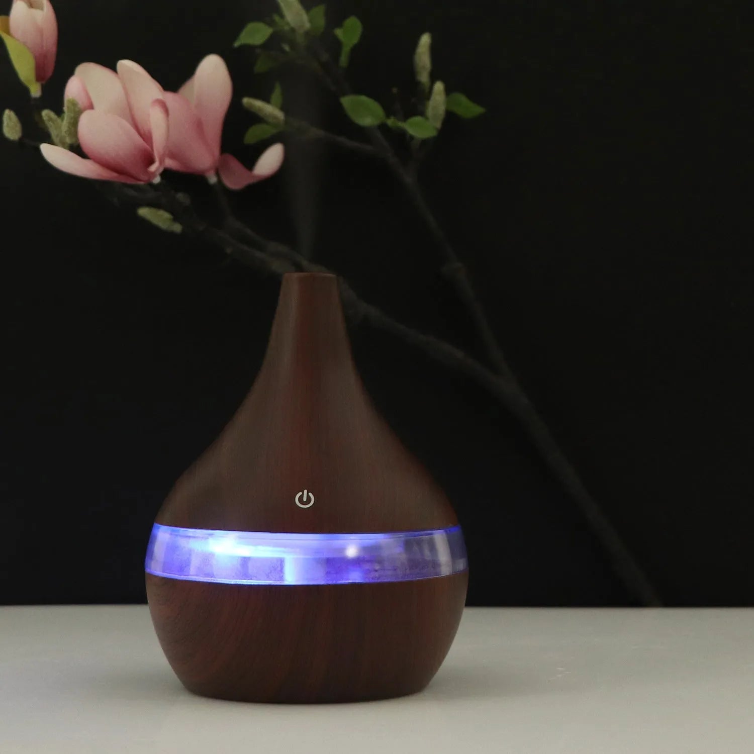 Columnar USB mini air purifier and humidifier in wood grain finish on a desk
