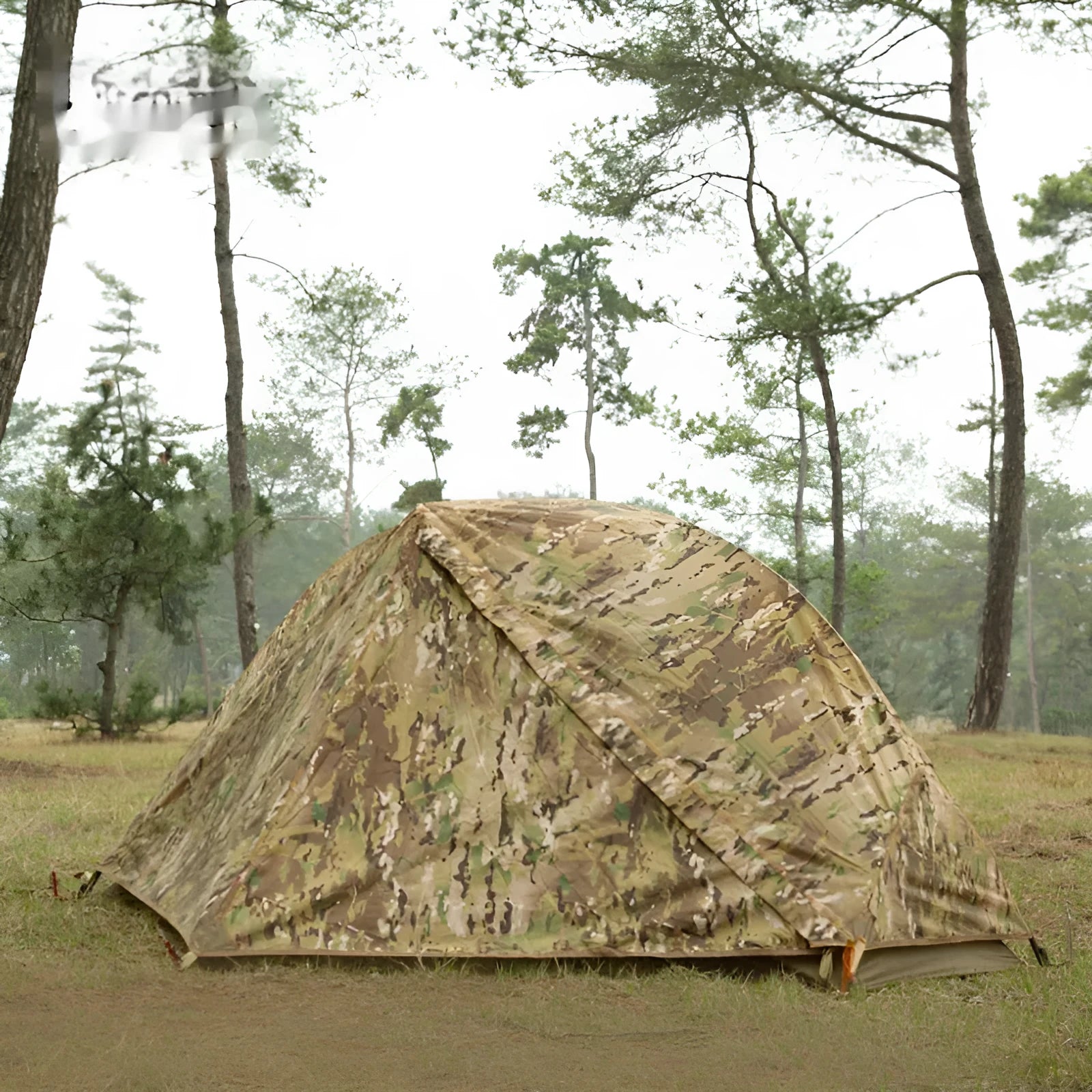 Single soldier camouflage tent shown in outdoor setting with rainproof and sun protection features for camping use