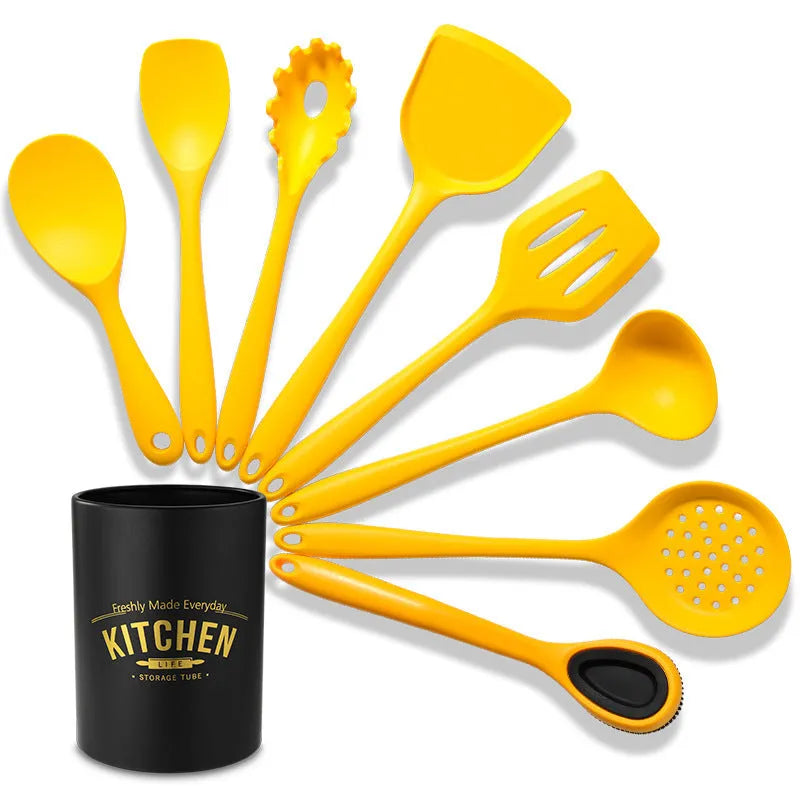 Yellow silicone nylon nonstick cooking spoon spatula kitchen utensils set on surface