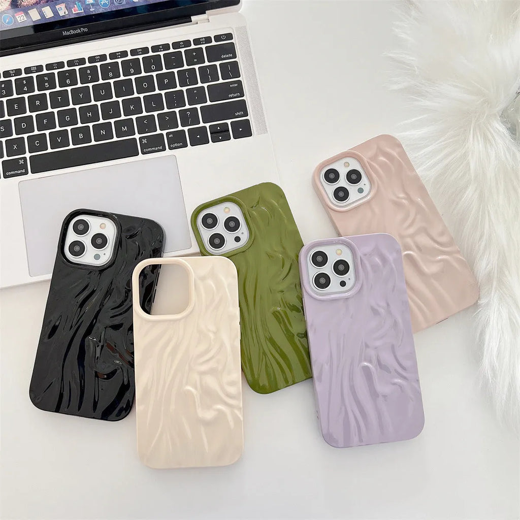 Milky white silicone iPhone case with a water ripple texture on a table.