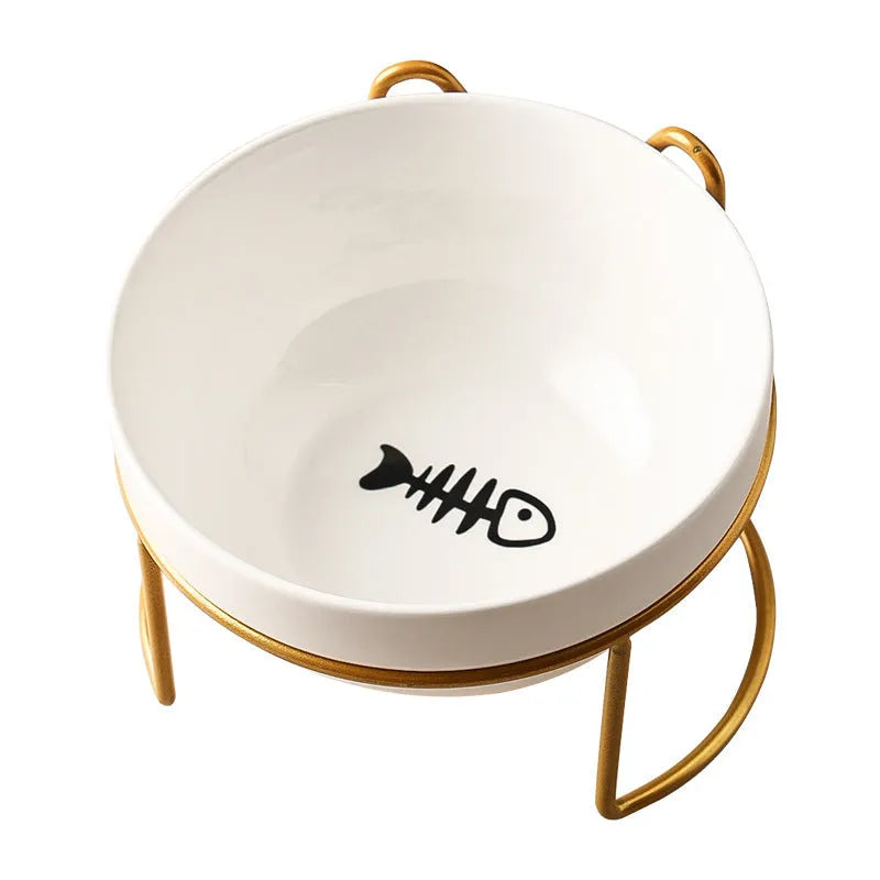 White ceramic cat bowl with cat footprint design on a black iron stand with cat ears.