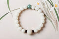Natural white jade Bodhi bracelet with round beads and transfer bead on white background