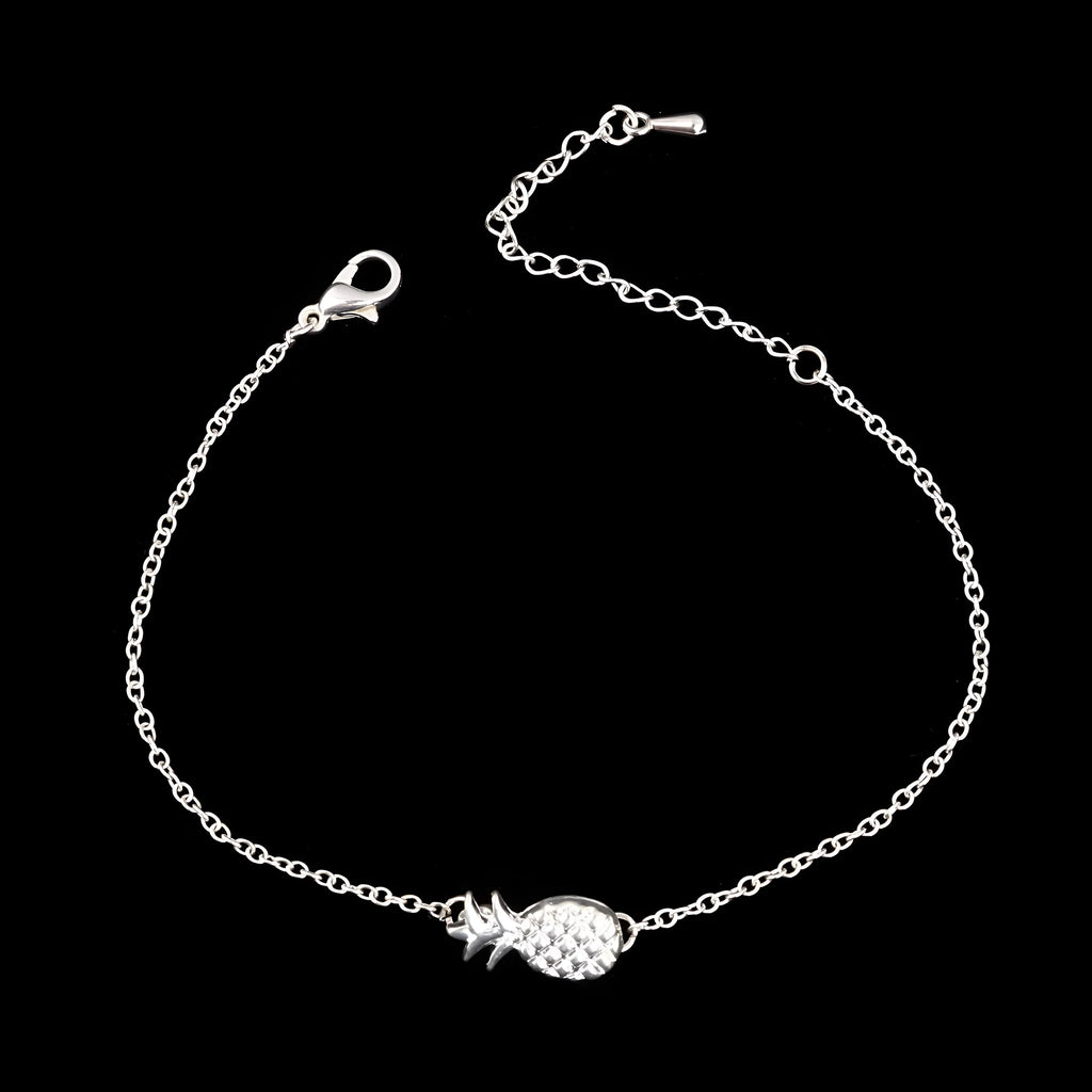 Close-up of a women's alloy bracelet with a detailed pineapple charm in gold or silver colour.