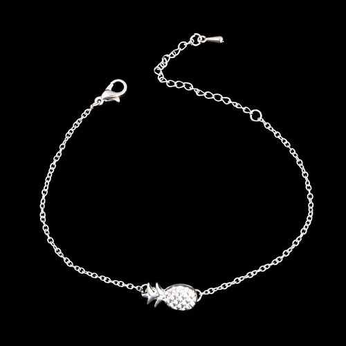 Close-up of a women's alloy bracelet featuring a detailed pineapple charm in gold or silver colour.