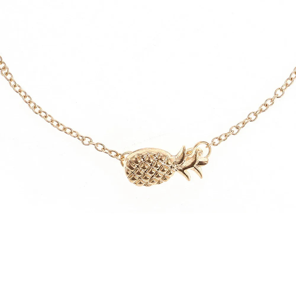 Close-up of a women's alloy bracelet with a detailed pineapple charm in gold or silver colour.