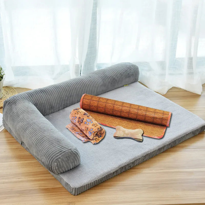 Corduroy bolster dog bed in grey colour, showing its non-slip base and high sides.