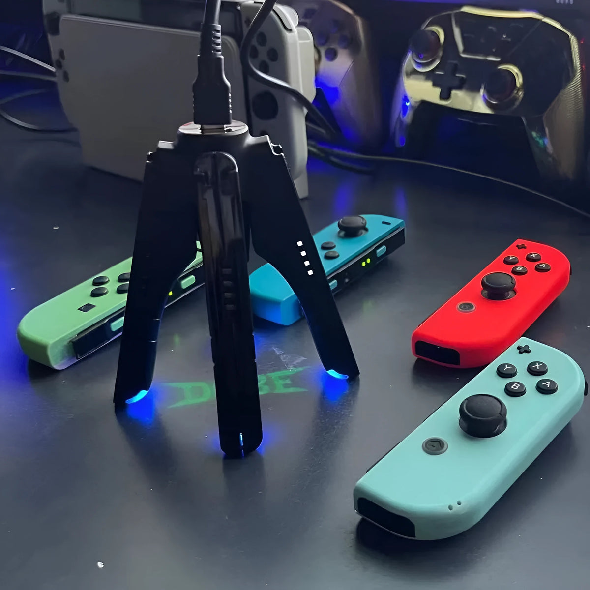Black ABS four-in-one Joy-Con charger holder with Type-C interface for Switch OLED and Switch rod end.