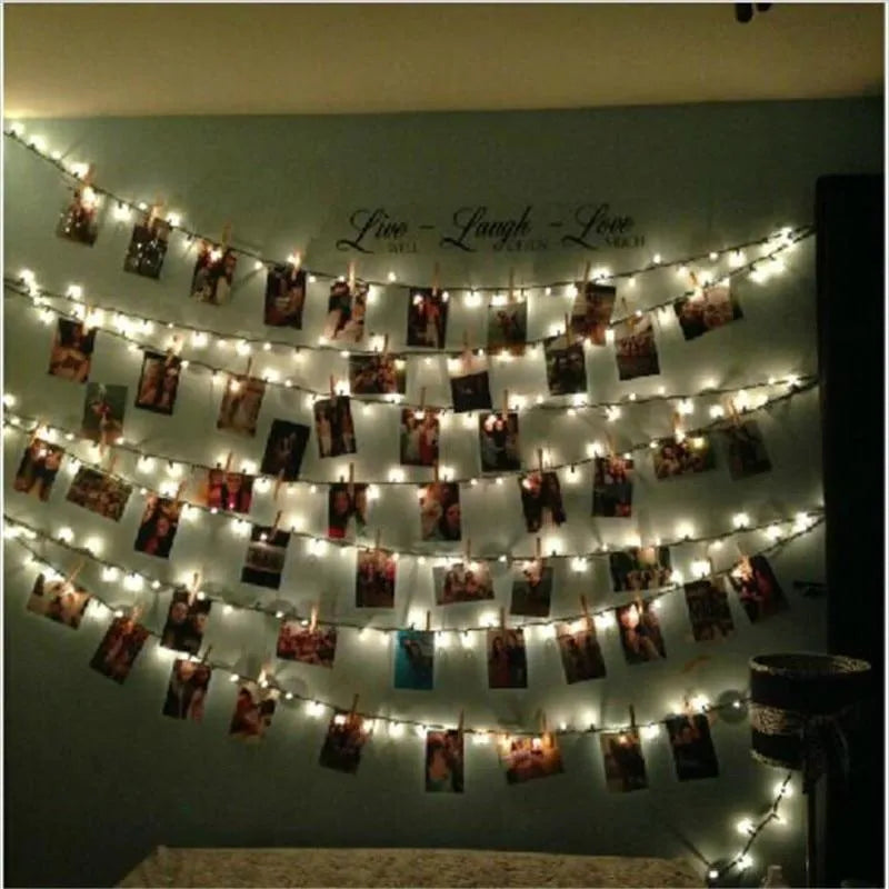 LED photo holder string lights with warm white bulbs and photo clips on a window display