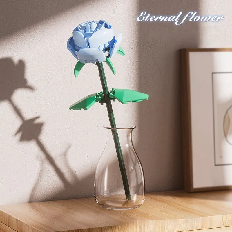 Rose assembled from small particle plastic building blocks in pink, red, or blue