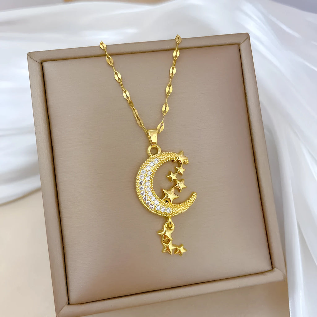 Geometric moon pendant necklace with tassel on a stainless steel chain, showing copper metal tone.