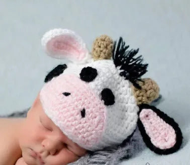 Hand-knitted white baby cow suit with matching pants and hat for newborns