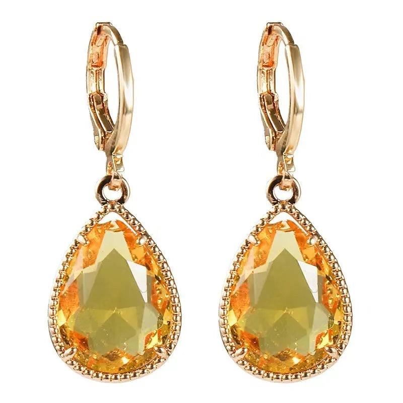 Copper-coloured rare earth metal and glass geometric saturn water drop earrings in multiple colours.