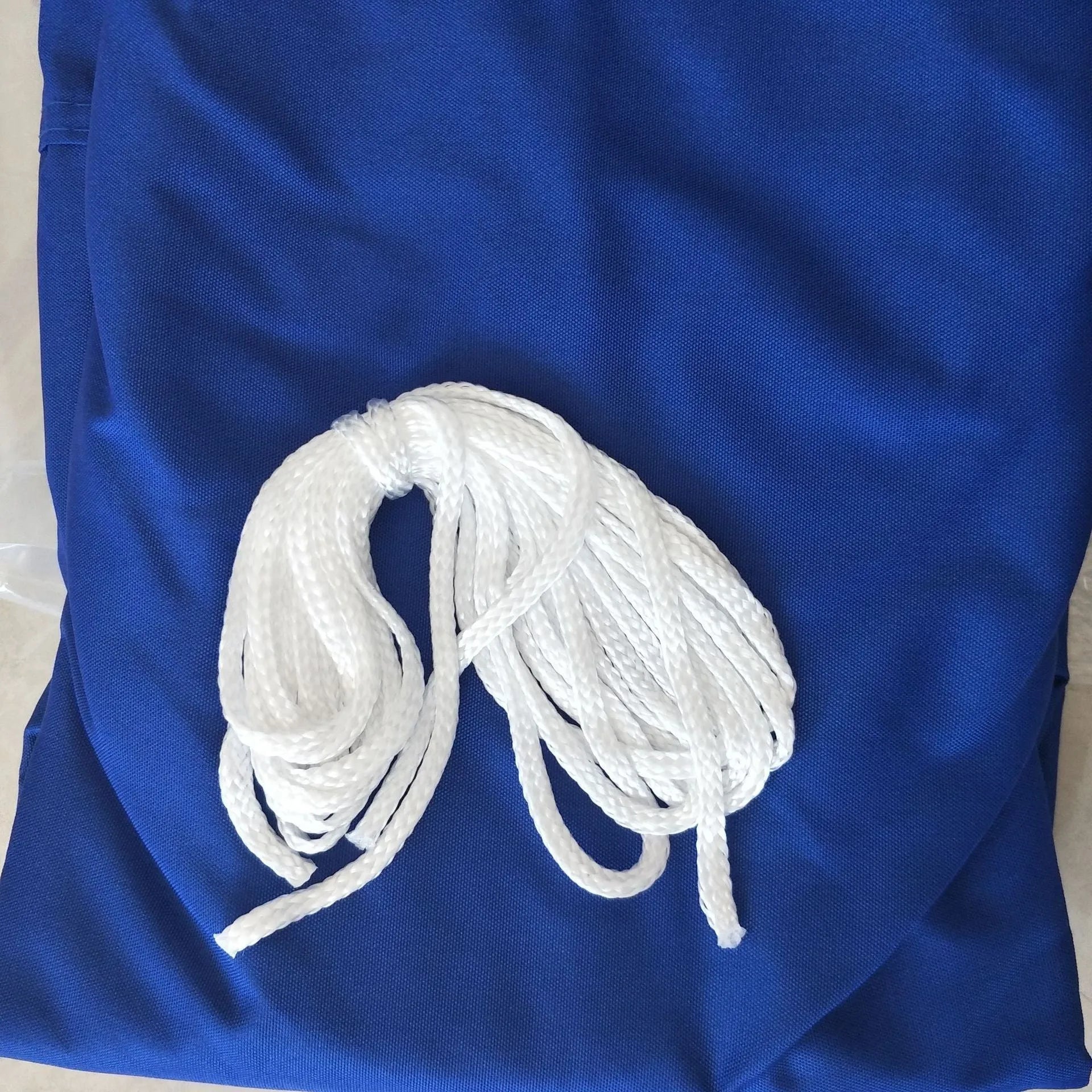 Curved square shade sail in blue colour measuring 3 metres by 4 metres