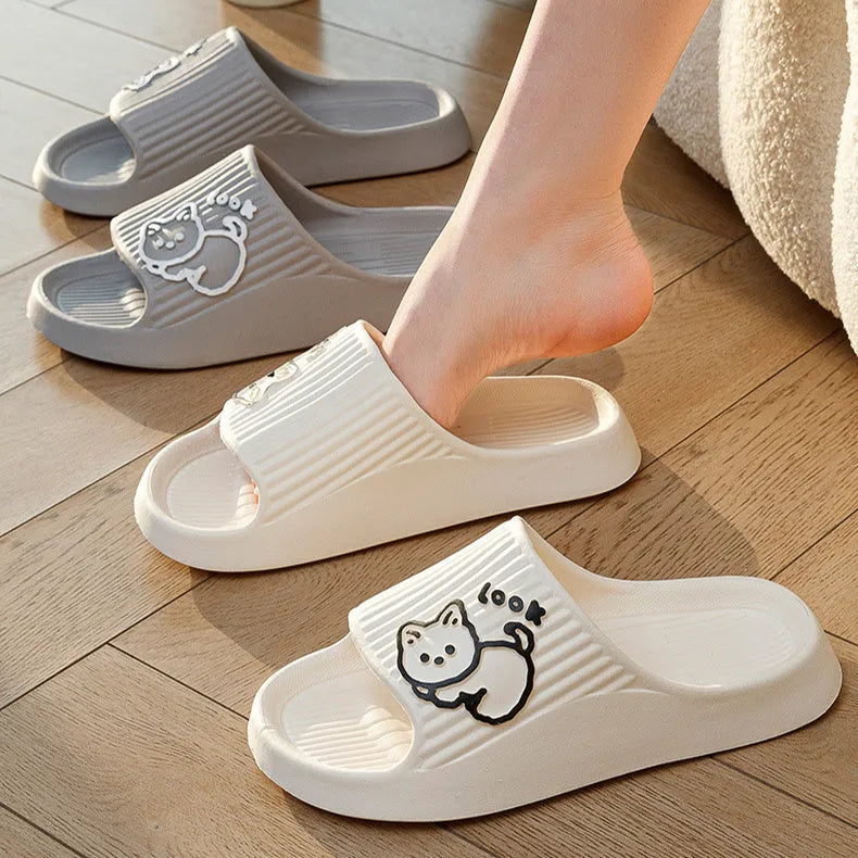 Women's green cat-themed platform slippers with non-slip EVA sole on a wooden floor.
