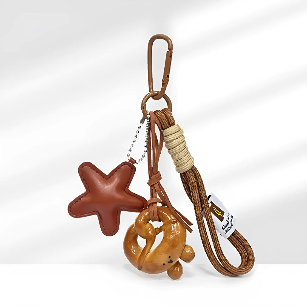 Handmade brown bread design bag pendant with a cartoon croissant on a brown strap.