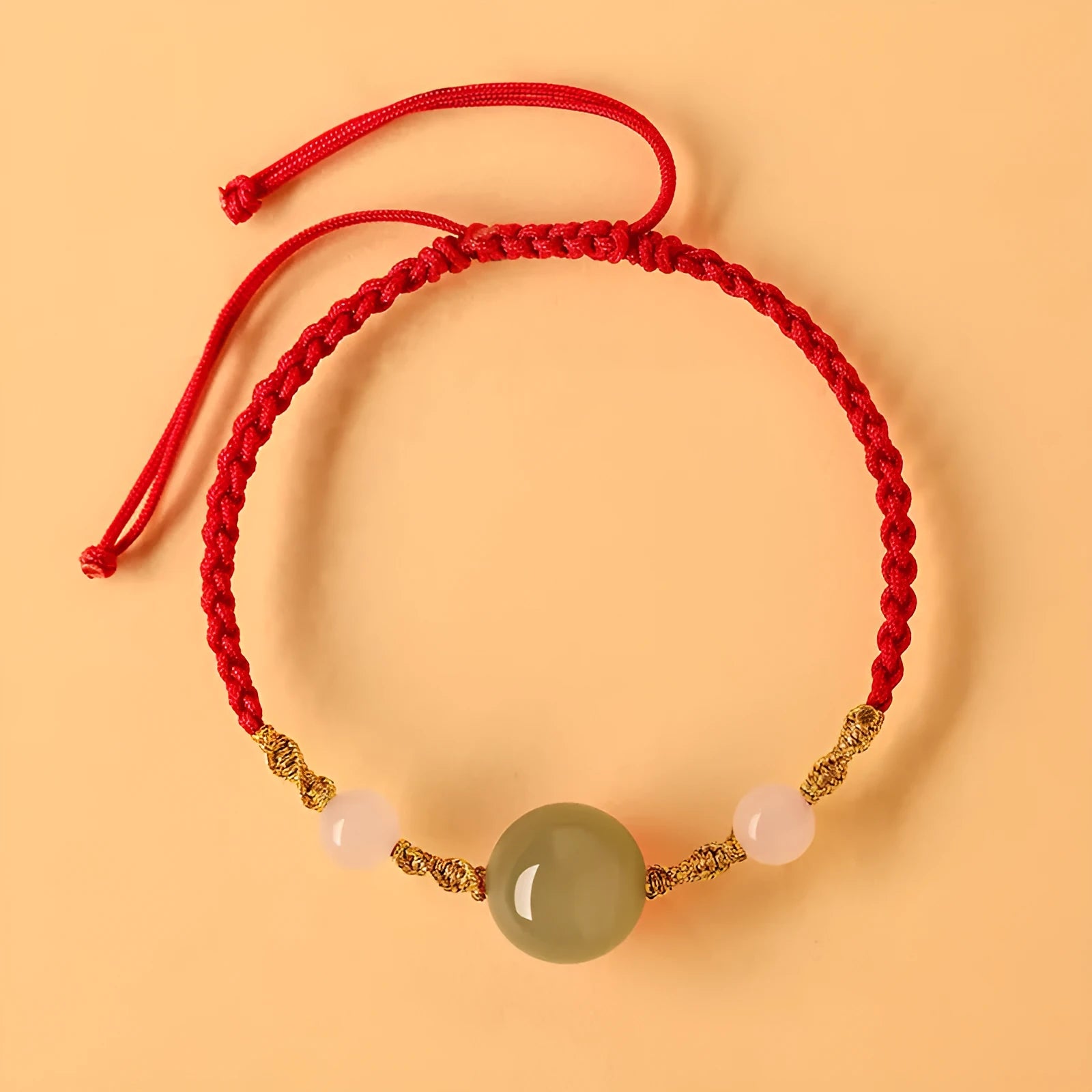 Hand-woven wine red rope bracelet with Hetian jade lucky beads and ethnic symbols.