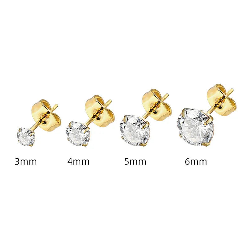 Simple geometric stud earrings with zircon stone in gold or steel colour on grey background.