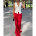 Women's beige two-piece set with sleeveless deep V-neck top and high-waisted wide-leg trousers